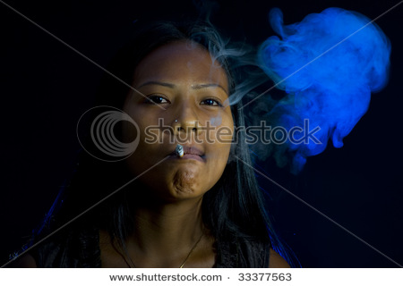 stock photo thai indian woman smoking in dark room
