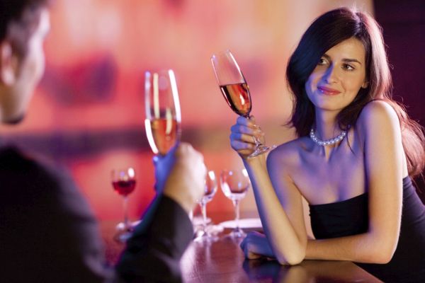 Amorous couple on romantic date or celebrating together at resta