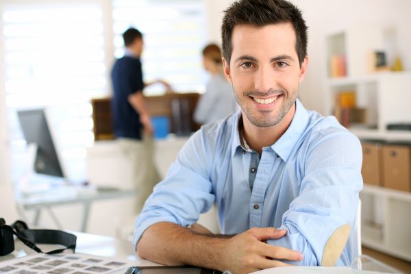 Portrait of cheerful man sitting in office