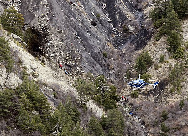 A French gendarme helicopter flies over the crash site of an Airbus A320, near Seyne-les-Alpes