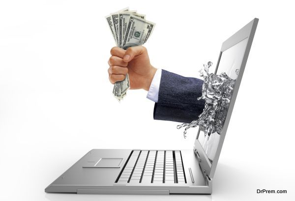 Human hand with money, coming out from computer screen.