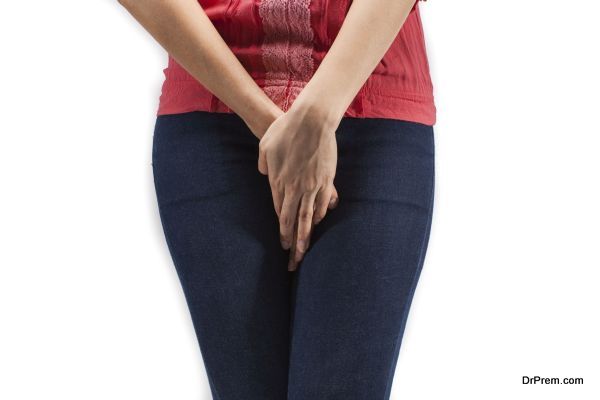 Close up of a woman with hands holding her crotch isolated in a white background