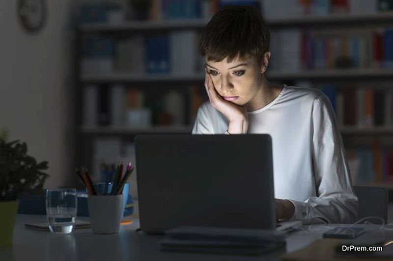Woman using a laptop late at night