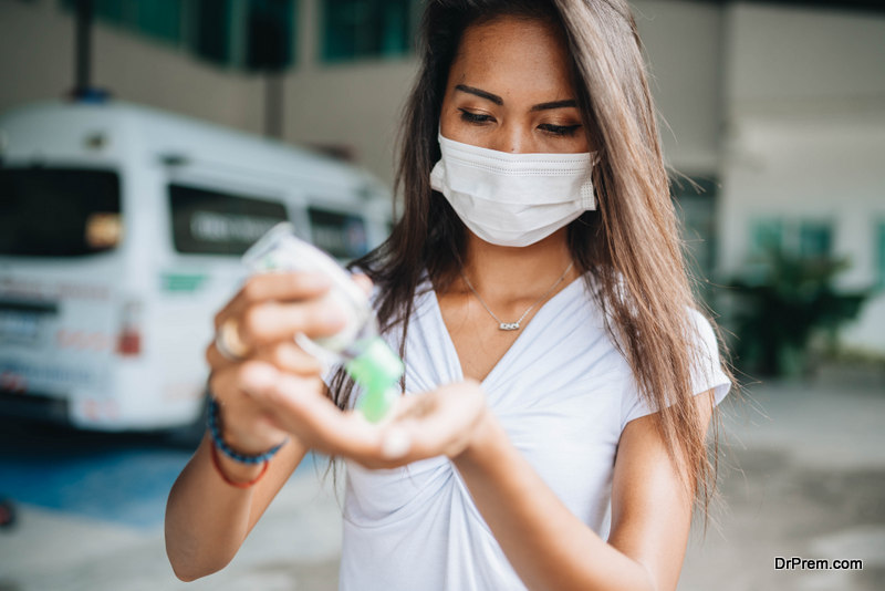 woman using sanitizer
