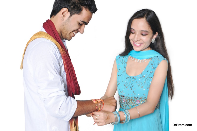 Sister tying Rakhi on her brother's wrist