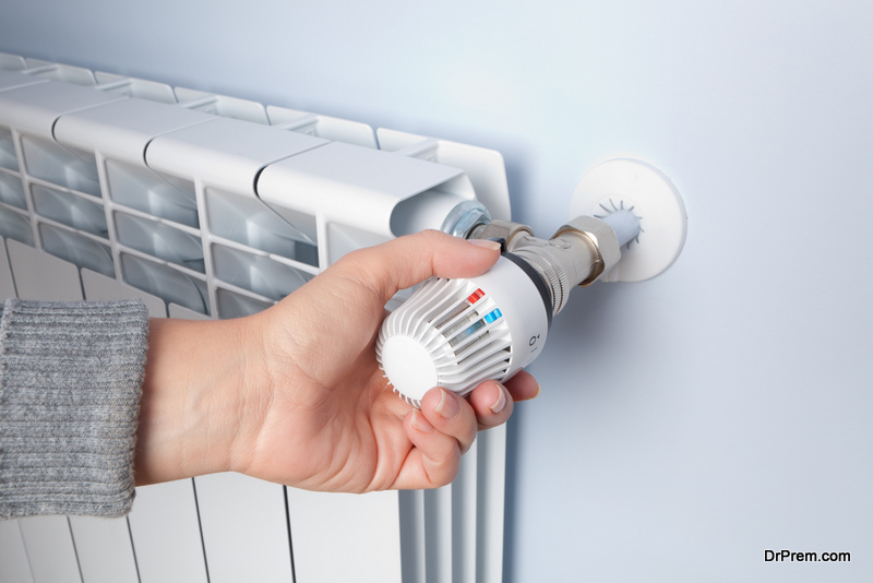 Woman's hand manipulating a thermostat